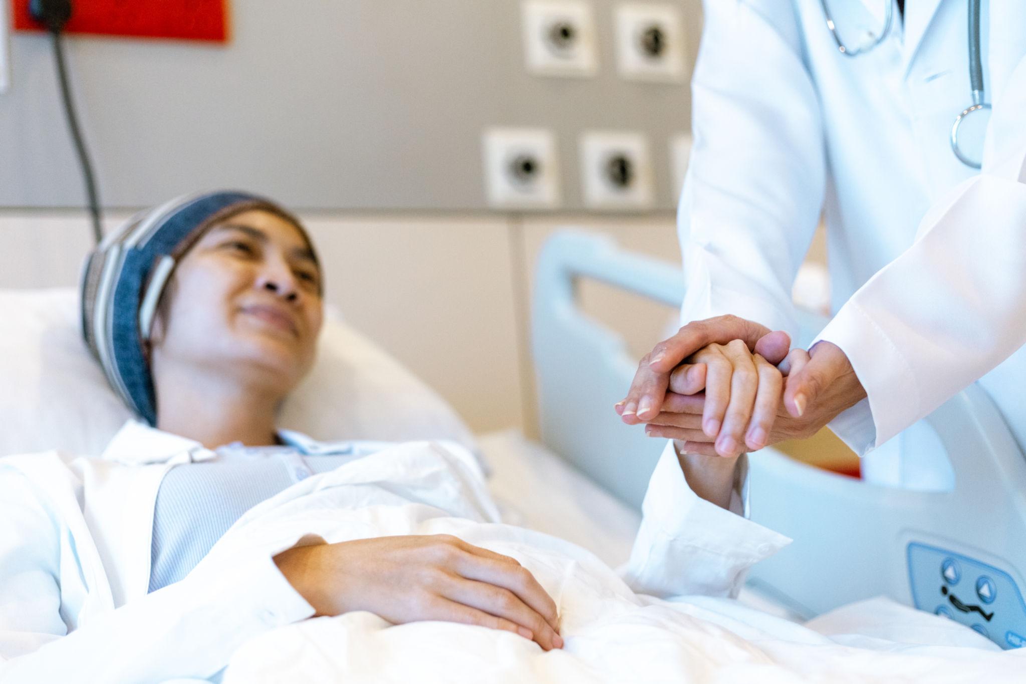 Doctor and patient holding hands